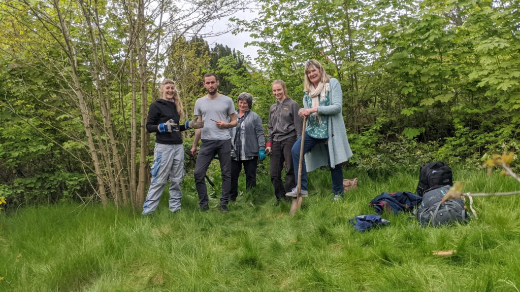 Fünf Personen im Garten beim "Ersten Spatenstich" im Mai 2023